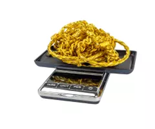 Scrap gold being weighed for valuation